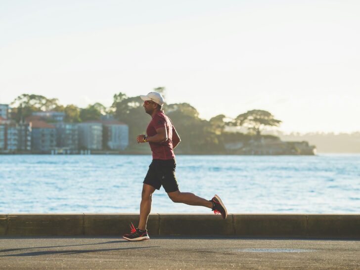 Guy running along waterfront