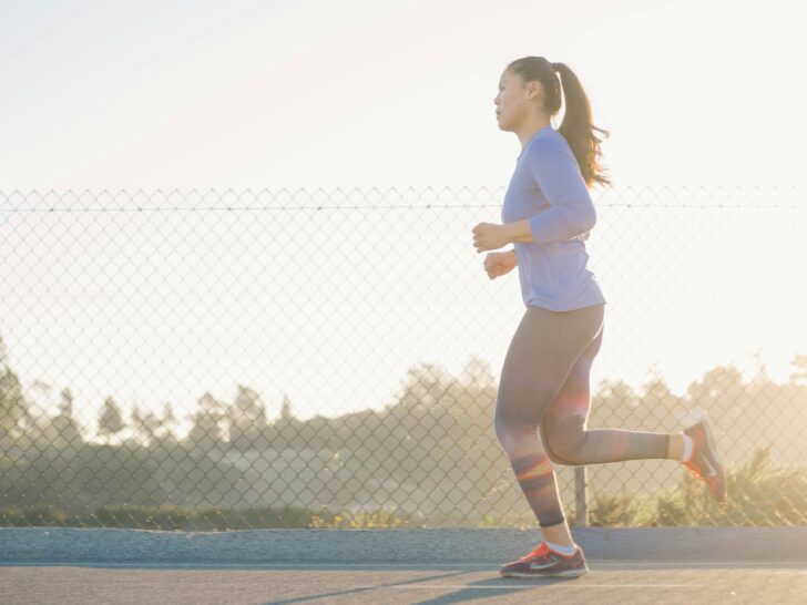 Woman Running with sunlight in background